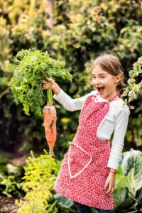 little girl holding a carrot