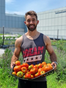 Farmer nick with basket of organic tomatoes