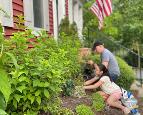 Man and daughter working in the garden