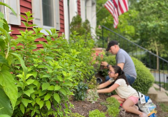 Man and daughter working in the garden