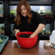 woman with hands in bowl of soil