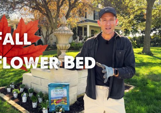 Kaleb Wyse in front of a flower bed