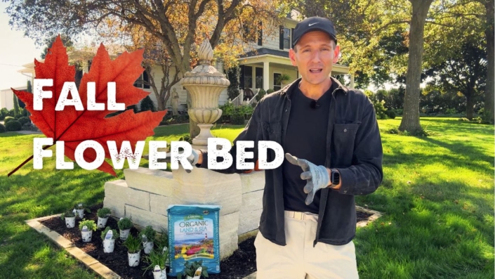Kaleb Wyse in front of a flower bed