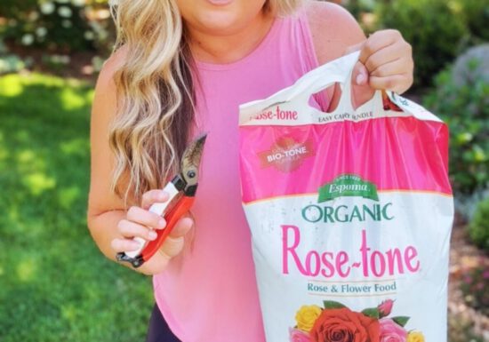 Skye Hamilton holding Espoma Organic Rose-tone (organic fertilizer for roses)