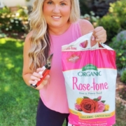 Skye Hamilton holding Espoma Organic Rose-tone (organic fertilizer for roses)